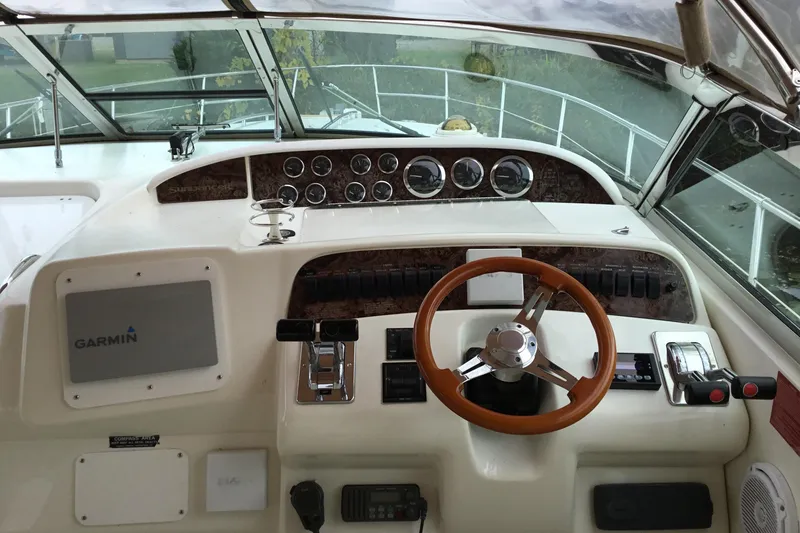 Slide: The Image of Cockpit of 1995 Sea Ray Sundancer 370 with Garmin navigation system and wooden steering wheel. - 4