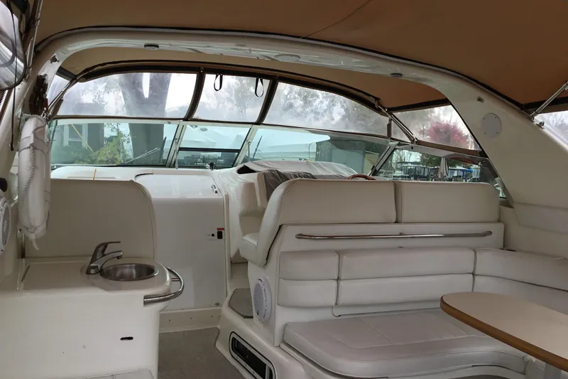 Slide: The Image of Interior of a 1995 Sea Ray Sundancer 370 yacht with white seating and a small sink. - 6