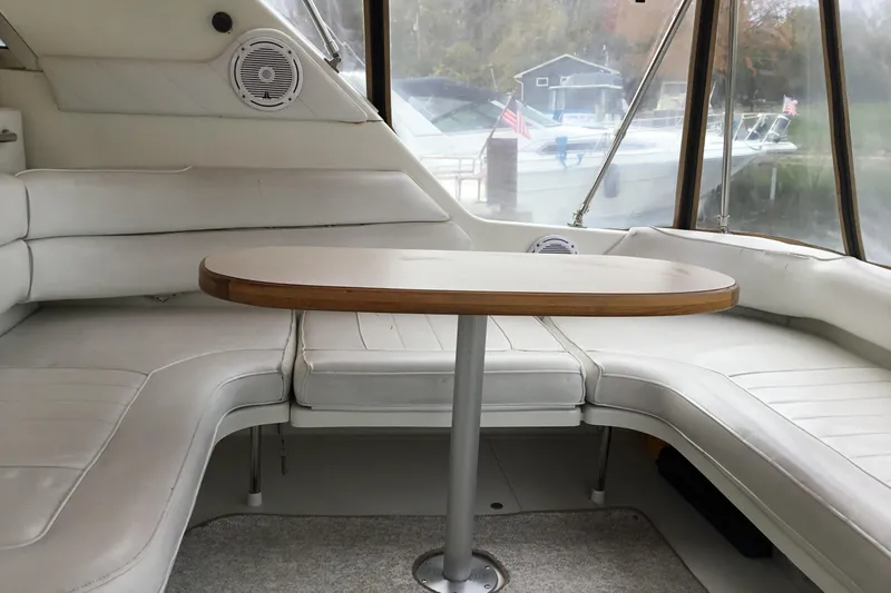 Slide: The Image of Interior of 1995 Sea Ray Sundancer 370 with white seating and oval table. - 8