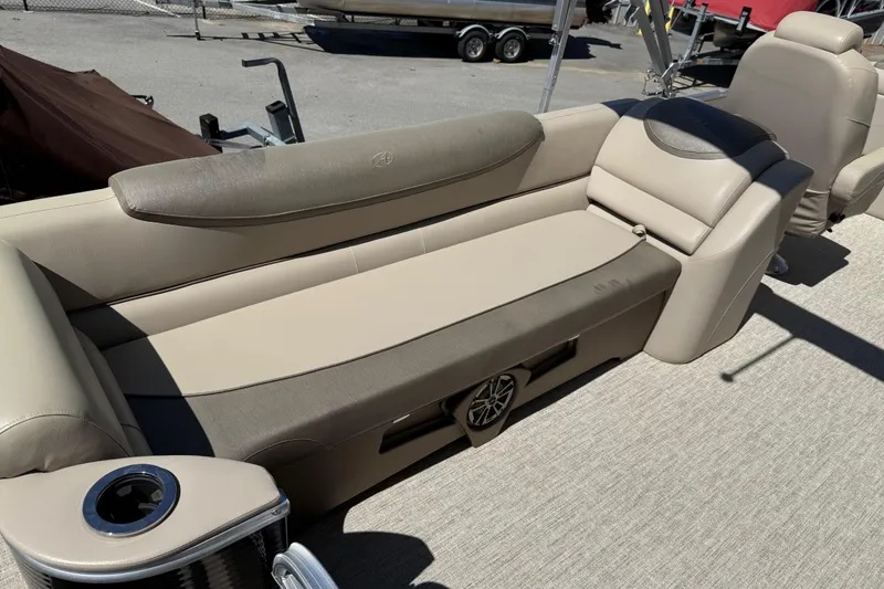 Slide: The Image of 2020 Avalon Catalina Quad Lounge 25' boat interior with beige seating and cup holder. - 14