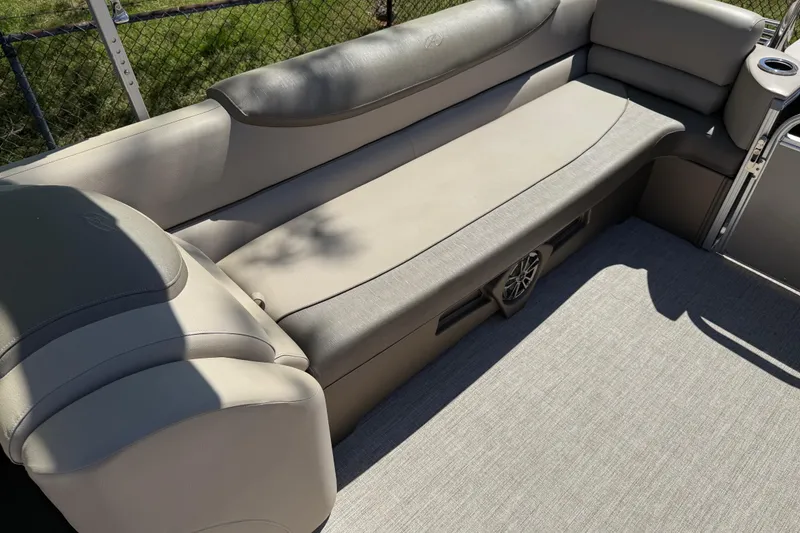 Slide: The Image of 2020 Avalon Catalina Quad Lounge 25' boat interior with beige seating and speaker. - 15
