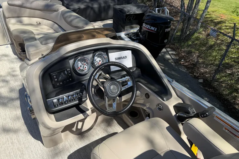 Slide: The Image of 2020 Avalon Catalina Quad Lounge boat dashboard with steering wheel and controls. - 16