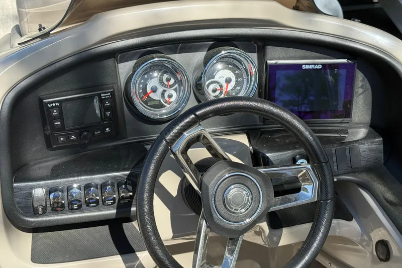 Slide: The Image of Dashboard of 2020 Avalon Catalina Quad Lounge boat with steering wheel and control gauges. - 18