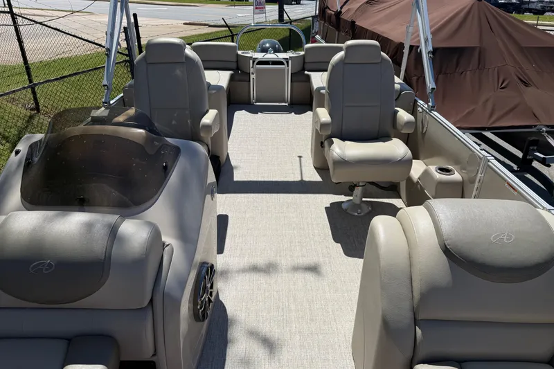 Slide: The Image of 2020 Avalon Catalina Quad Lounge 25' pontoon boat interior with plush seating and helm. - 5