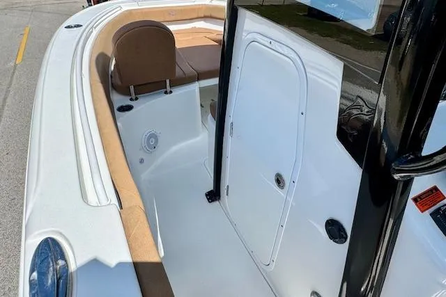 Slide: The Image of 2022 Sea Hunt Ultra 255 SE boat interior with seating and storage compartment. - 12