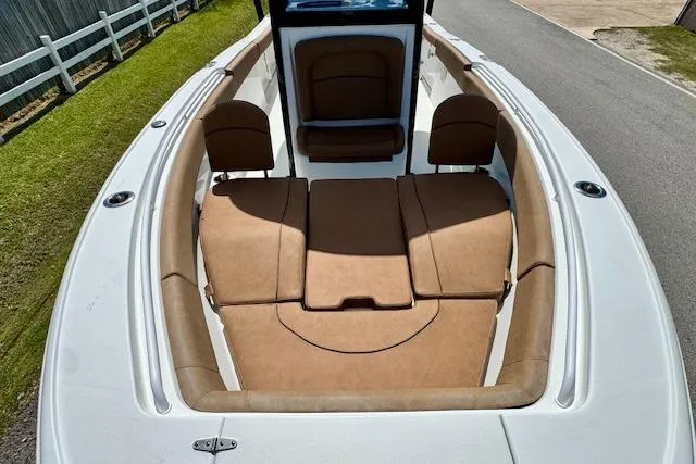 Slide: The Image of 2022 Sea Hunt Ultra 255 SE boat with tan seating and spacious deck layout. - 16