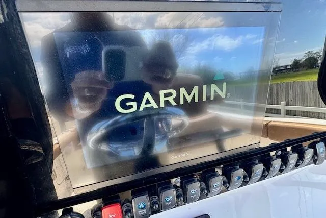 Slide: The Image of Garmin display on 2022 Sea Hunt Ultra 255 SE boat dashboard with control panel. - 17