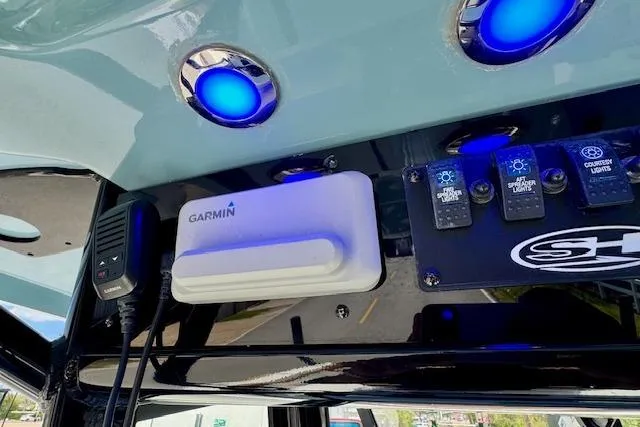 Slide: The Image of Control panel of 2022 Sea Hunt Ultra 255 SE with Garmin device and illuminated switches. - 18