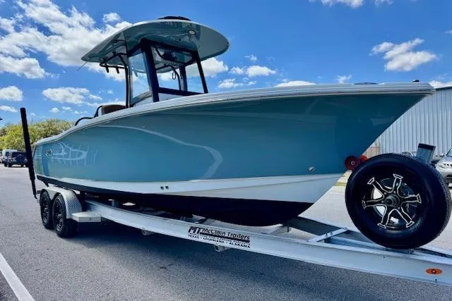 Slide: The Image of 2022 Sea Hunt Ultra 255 SE boat on trailer under blue sky. - 5