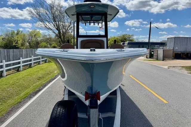 Slide: The Image of 2022 Sea Hunt Ultra 255 SE boat on trailer, parked on a sunny road. - 6