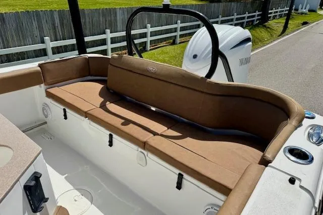 Slide: The Image of 2022 Sea Hunt Ultra 255 SE boat with brown seating and Yamaha engine. - 7