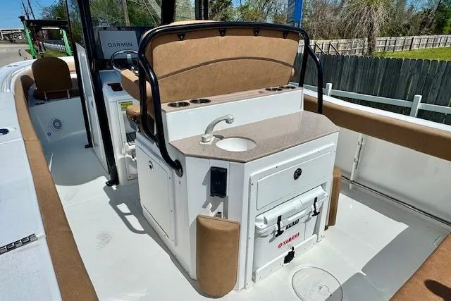 Slide: The Image of 2022 Sea Hunt Ultra 255 SE boat interior with helm station and sink. - 8