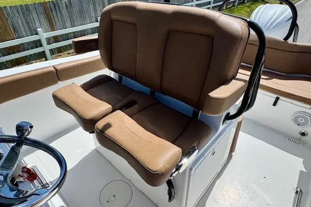 Slide: The Image of Brown captain's seat on 2022 Sea Hunt Ultra 255 SE boat deck. - 9
