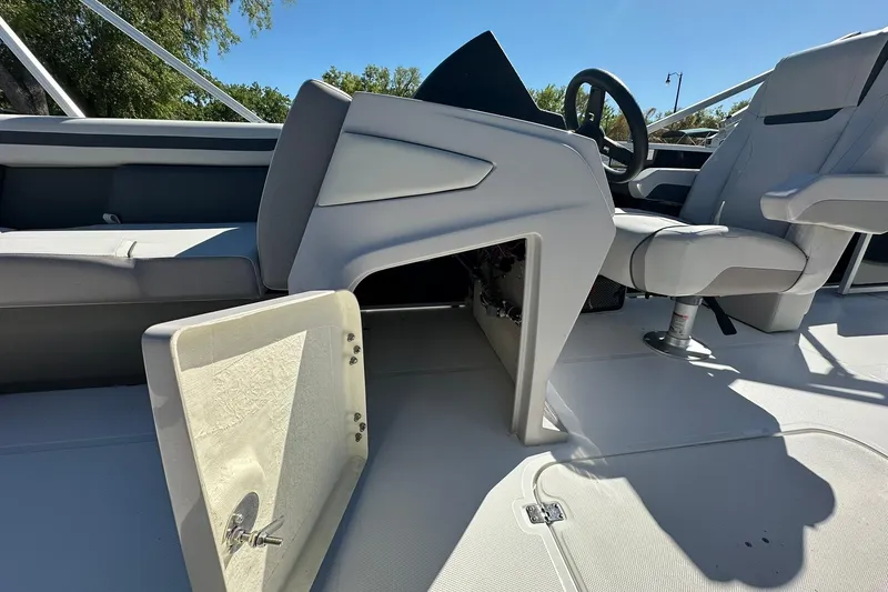Slide: The Image of 2026 Sweetwater FD2260RE3 boat interior with open storage compartment and seating. - 13