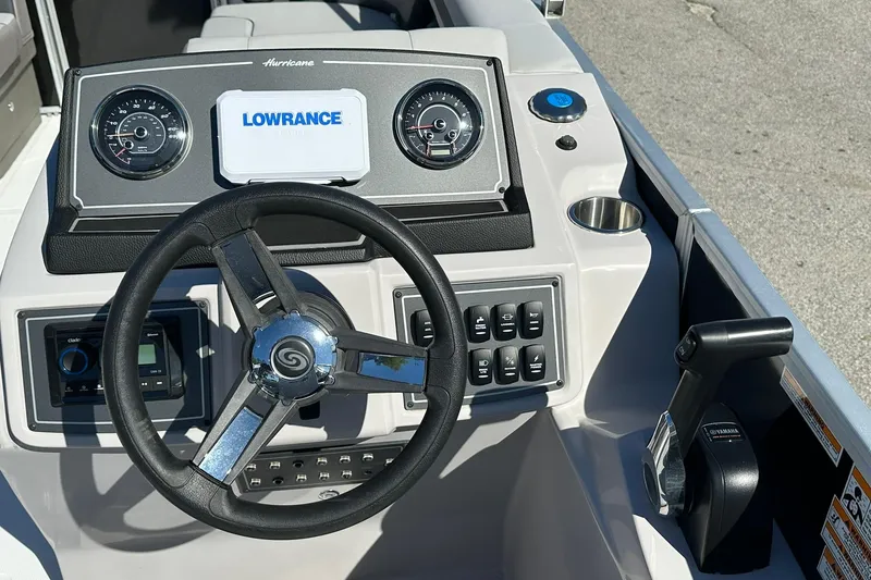 Slide: The Image of Steering console of 2026 Sweetwater FD2260RE3 boat with Lowrance display and controls. - 14