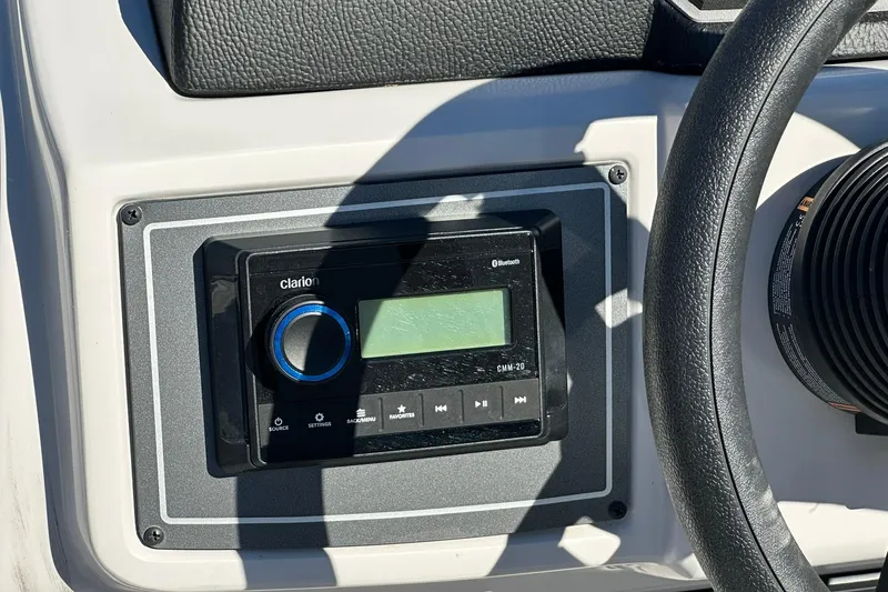 Slide: The Image of Clarion Bluetooth stereo system on Sweetwater FD2260RE3, 2026 model boat dashboard. - 15