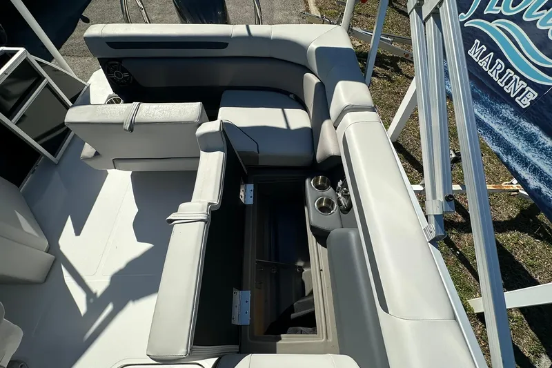 Slide: The Image of Luxurious seating on 2026 Sweetwater FD2260RE3 boat with storage and cup holders. - 21