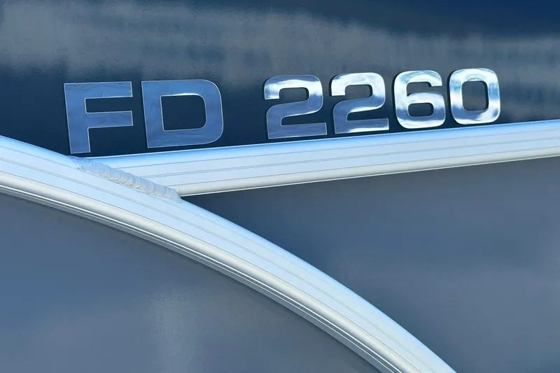 Slide: The Image of Sweetwater FD2260RE3 2026 model emblem on a sleek metallic surface. - 22