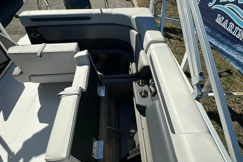 Slide: The Image of Sweetwater FD2260RE3 2026 boat interior with seating and cup holders. - 24