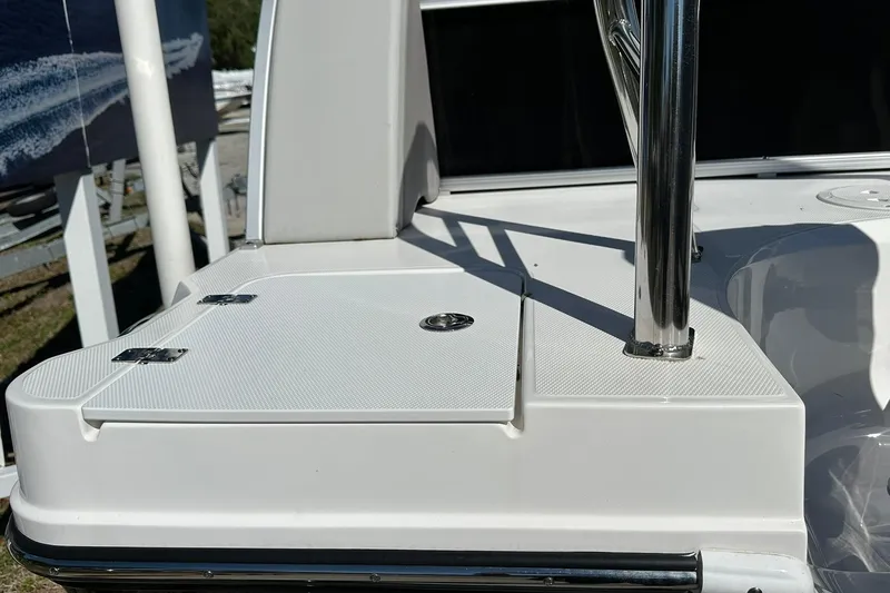 Slide: The Image of 2026 Sweetwater FD2260RE3 boat deck with stainless steel railing and storage compartment. - 26