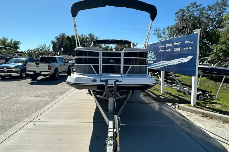 Slide: The Image of 2026 Sweetwater FD2260RE3 pontoon boat on trailer, sunny day, dealership background. - 3