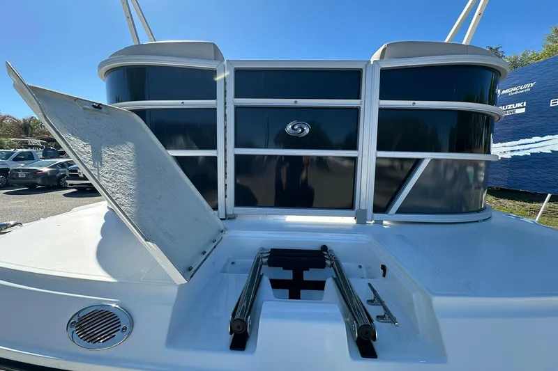Slide: The Image of 2026 Sweetwater FD2260RE3 boat with open storage compartment and ladder on deck. - 4