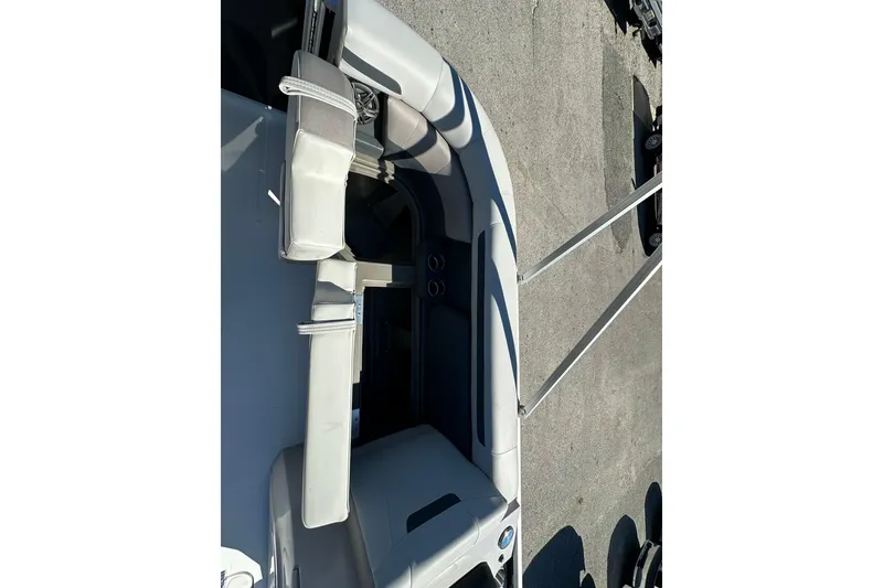 Slide: The Image of 2026 Sweetwater FD2260RE3 boat interior with gray seating and steering wheel. - 6