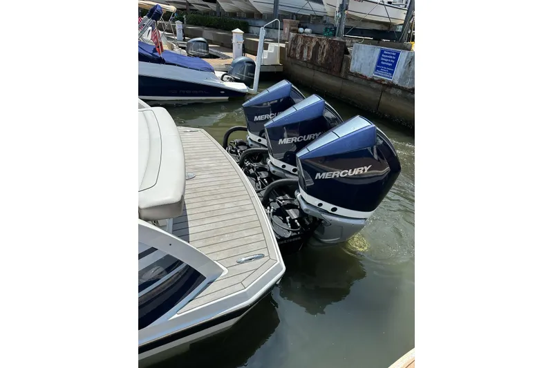 Slide: The Image of 2021 Formula 330 Crossover Bowrider OB with triple Mercury outboard engines docked. - 11