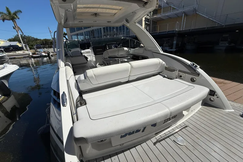 Slide: The Image of 2021 Formula 330 Crossover Bowrider OB at dock, showcasing spacious seating and sleek design. - 12