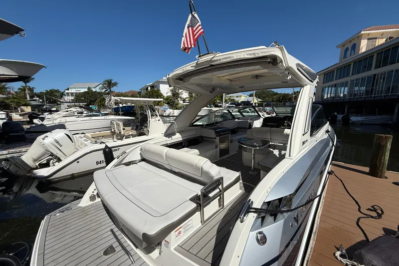 Slide: The Image of 2021 Formula 330 Crossover Bowrider OB docked, showcasing spacious seating and sleek design. - 13