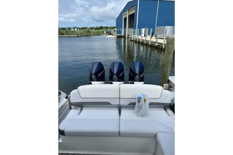 Slide: The Image of 2021 Formula 330 Crossover Bowrider OB with triple Mercury outboard engines docked by marina. - 15