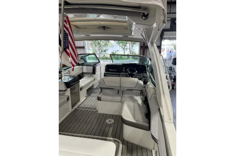 Slide: The Image of 2021 Formula 330 Crossover Bowrider OB interior with seating and helm, featuring sleek design. - 16