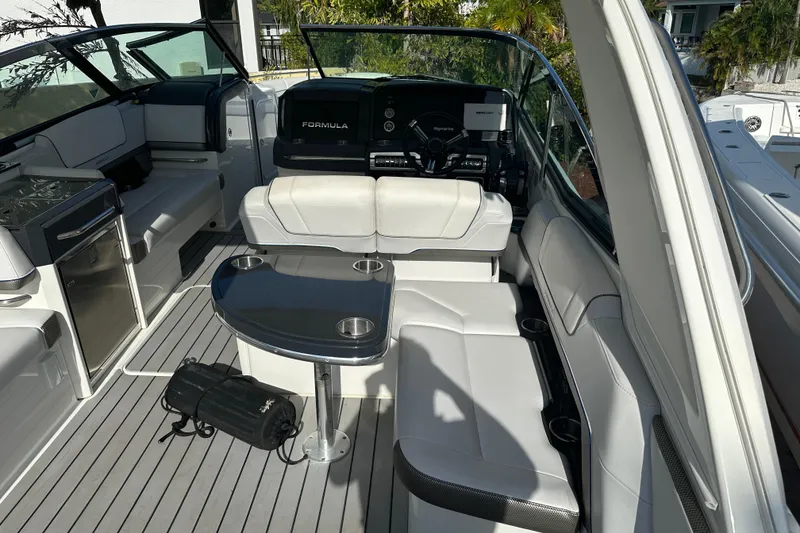 Slide: The Image of 2021 Formula 330 Crossover Bowrider OB interior with seating and table. - 23