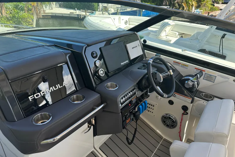 Slide: The Image of 2021 Formula 330 Crossover Bowrider OB cockpit with modern controls and steering wheel. - 29