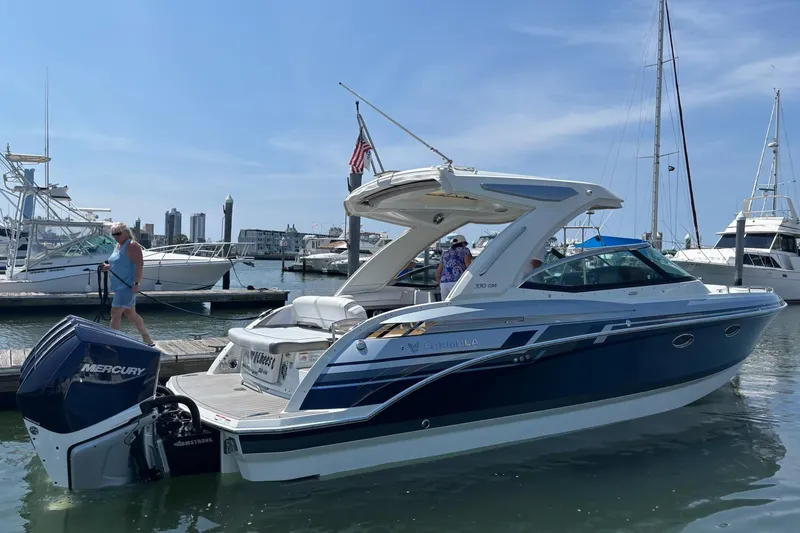 Slide: The Image of 2021 Formula 330 Crossover Bowrider OB docked at marina with Mercury outboard. - 3