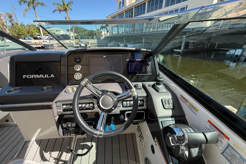 Slide: The Image of 2021 Formula 330 Crossover Bowrider OB helm with steering wheel and control panel. - 30