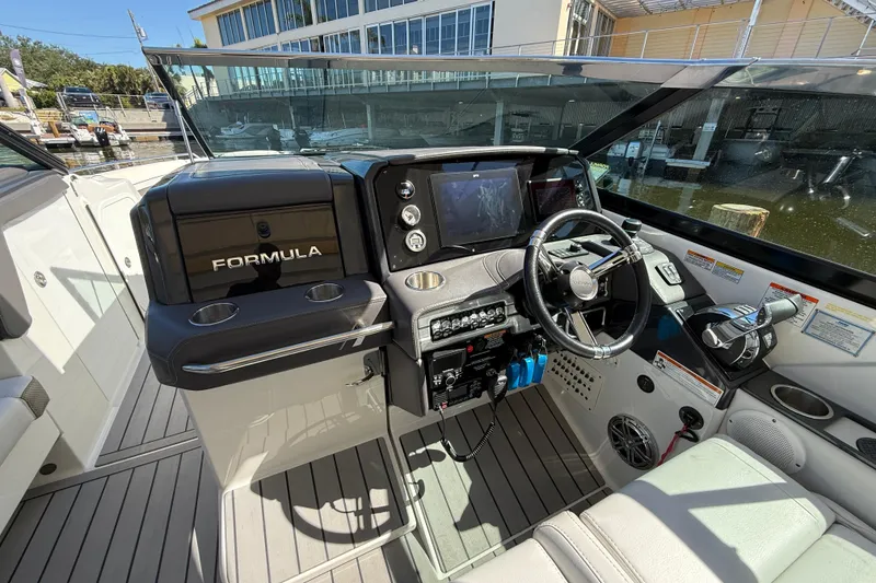 Slide: The Image of 2021 Formula 330 Crossover Bowrider OB cockpit with steering wheel and control panel. - 31