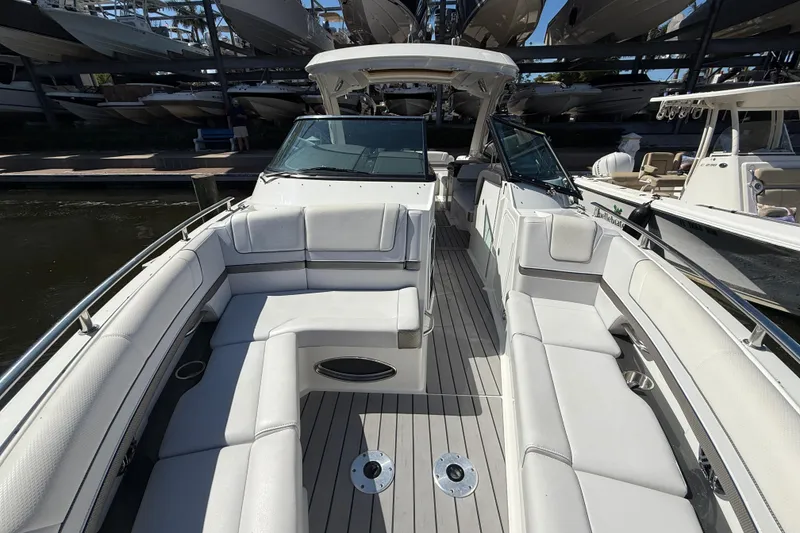 Slide: The Image of 2021 Formula 330 Crossover Bowrider OB with spacious seating and sleek design in marina. - 33