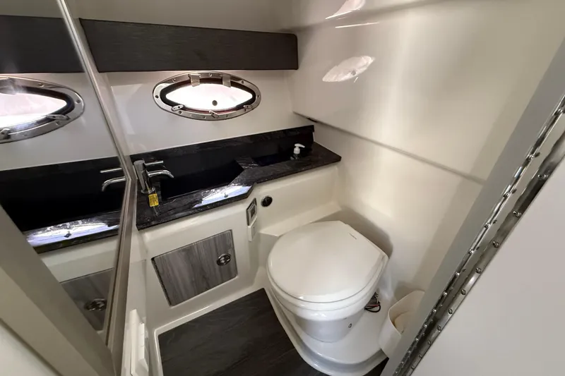 Slide: The Image of 2021 Formula 330 Crossover Bowrider OB bathroom with modern fixtures and porthole window. - 38