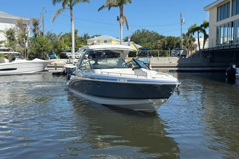 Slide: The Image of 2021 Formula 330 Crossover Bowrider OB in a sunny marina setting. - 4