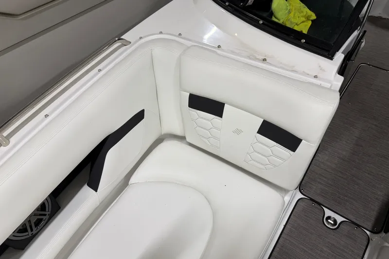 Slide: The Image of 2024 Four Winns HD5 boat interior with white cushioned seating and sleek design. - 14