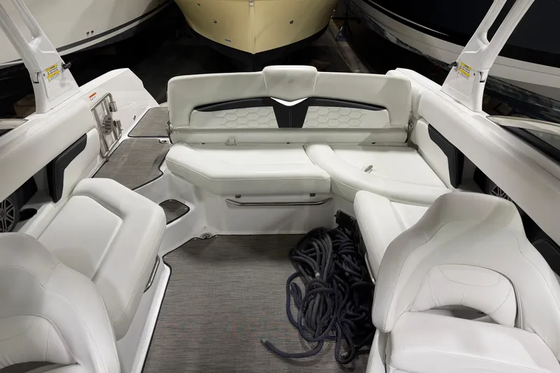 Slide: The Image of 2024 Four Winns HD5 boat interior with white seating and coiled ropes. - 16