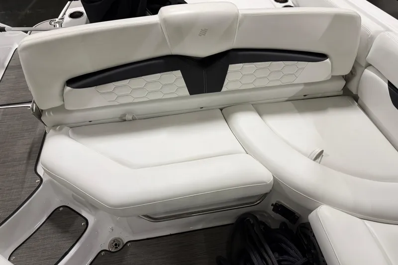 Slide: The Image of 2024 Four Winns HD5 boat interior with white cushioned seating and modern design. - 20