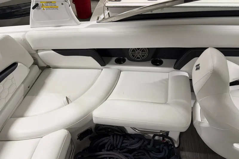 Slide: The Image of 2024 Four Winns HD5 boat interior with white seating and speaker system. - 21