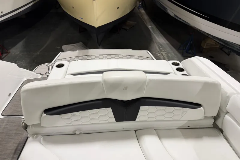 Slide: The Image of 2024 Four Winns HD5 boat interior with white seating and cup holders. - 22