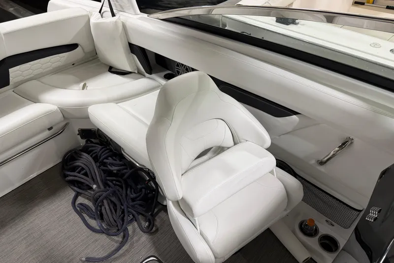 Slide: The Image of 2024 Four Winns HD5 boat interior with white seating and coiled rope. - 23