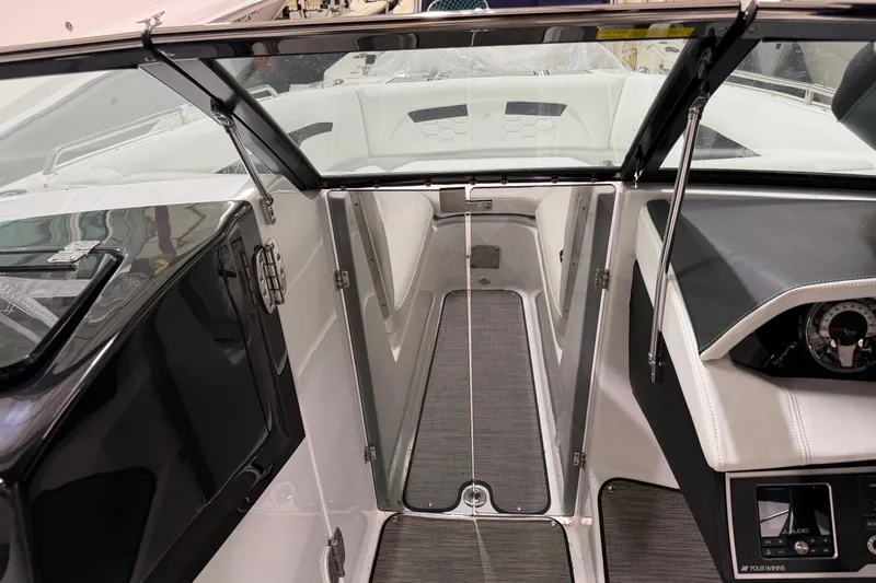 Slide: The Image of 2024 Four Winns HD5 boat interior with sleek design and modern dashboard. - 26