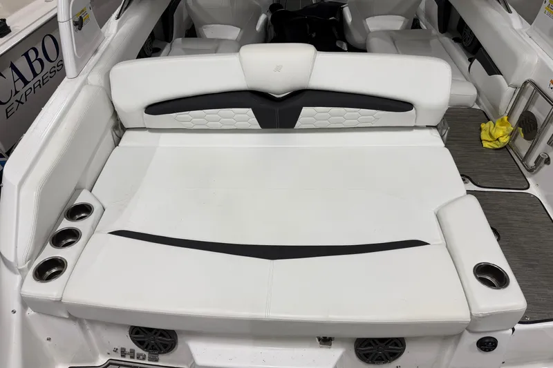 Slide: The Image of 2024 Four Winns HD5 boat interior with white seating and cup holders. - 27
