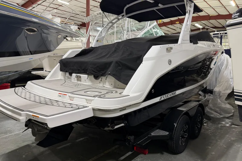 Slide: The Image of 2024 Four Winns HD5 boat in storage, covered and on a trailer. - 3