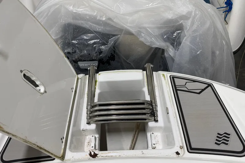 Slide: The Image of 2024 Four Winns HD5 boat with folded stainless steel ladder and storage compartment. - 38